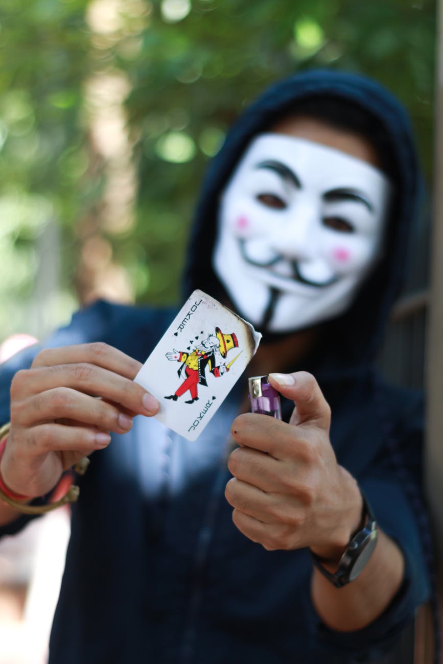 person burning card with joker